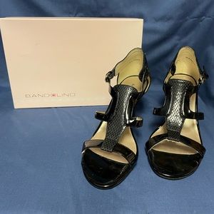 Black high heeled sandals.